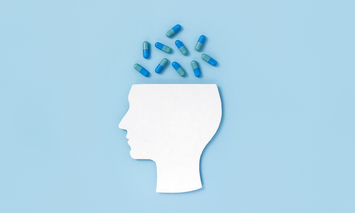 Pills coming out of a head. Credit: ClareM / Shutterstock.