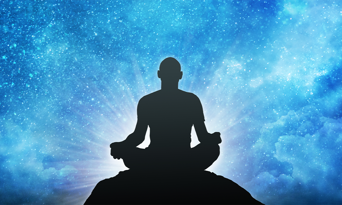 Silhouette of man meditating against a blue sky background. Credit: varuna / Shutterstock.