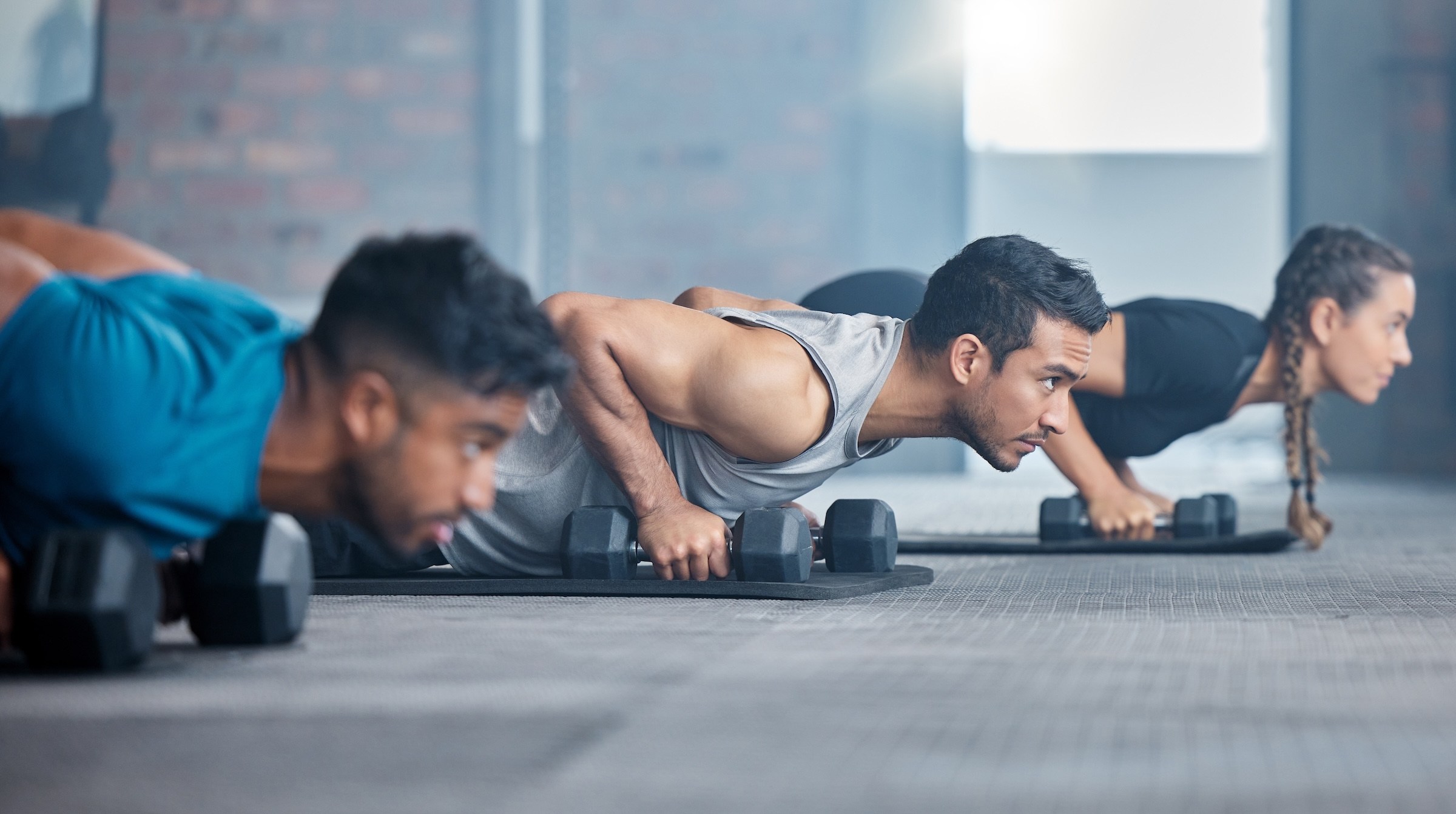 Three people doing a functional fitness workout class.