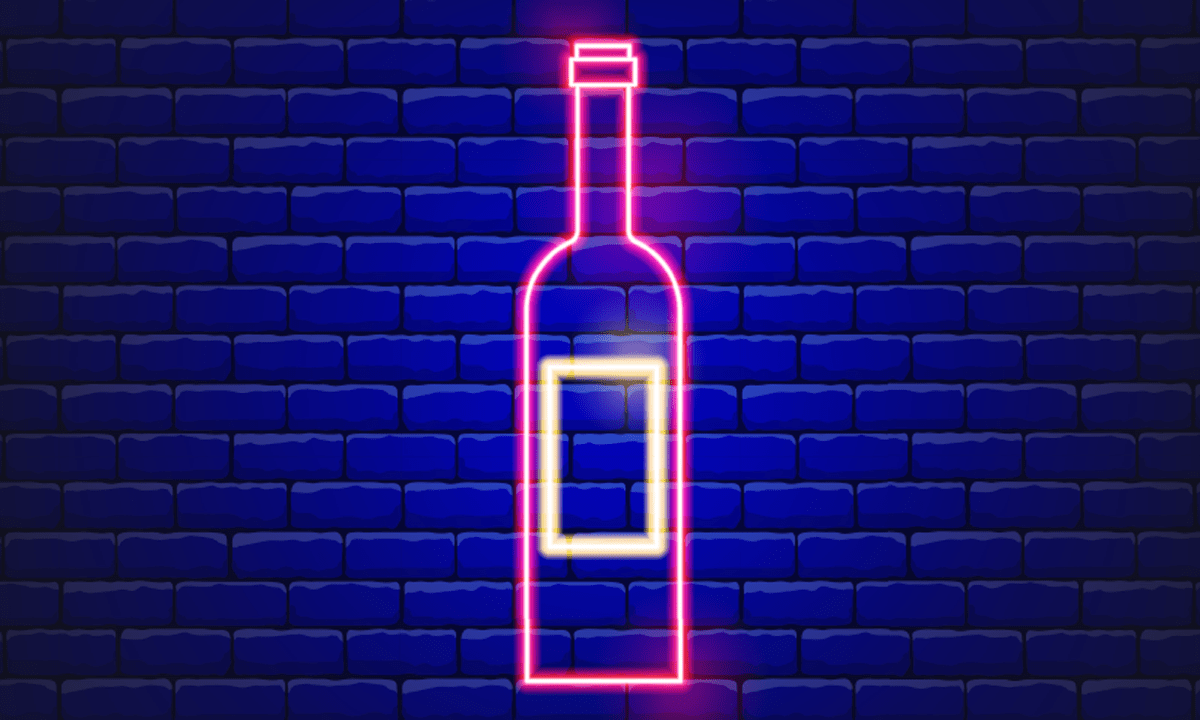 An illustration of a neon wine bottle against a brick wall.